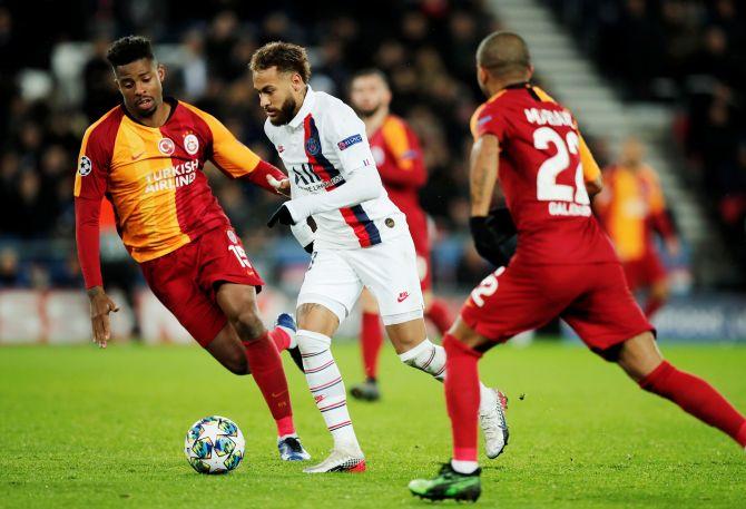 Paris St Germain's Neymar beats Galatasaray's Ryan Donk to the ball during their Champions League Group A match at Parc des Princes in Paris, France