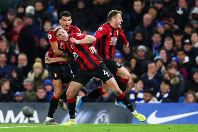 AFC Bournemouth's Dan Gosling celebrates with teammates Dominic Solanke and Ryan Fraser after scoring against Chelsea at Stamford Bridge in London