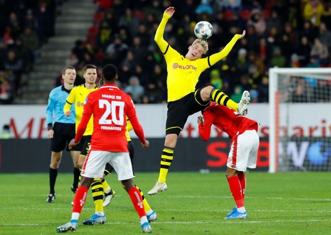 Borussia Dortmund's Julian Brandt wins an aerial ball against 1.FSV Mainz 05's Jean Paul Boetius during their Bundesliga match at Opel Arena in Mainz