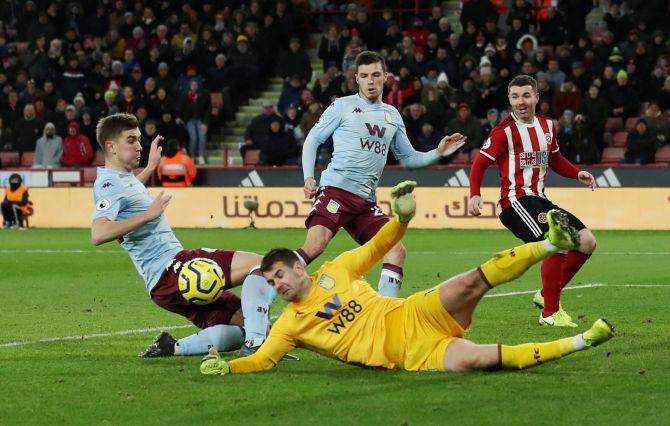 Aston Villa's Tom Heaton and Bjorn Engels in action with Sheffield United's John Fleck during their match at Bramall Lane in Sheffield