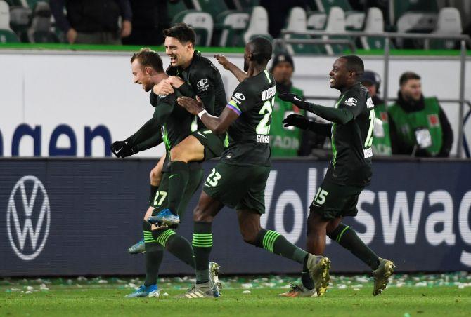 VfL Wolfsburg's Maximilian Arnold celebrates with teammates on scoring their second goal against Borussia Moenchengladbach during their Bundesliga match at Volkswagen Arena in Wolfsburg