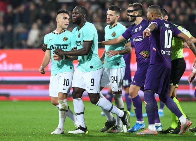 Inter Milan's Lautaro Martinez clashes with Fiorentina's Kevin-Prince Boateng during their Serie A match at Stadio Artemio Franchi in Florence