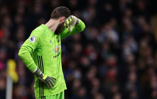Manchester United's David de Gea reacts after a keeping error at Vicarage Road in Watford