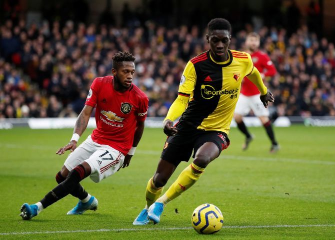Watford's Ismaila Sarr and Manchester United's Fred vie for possession 