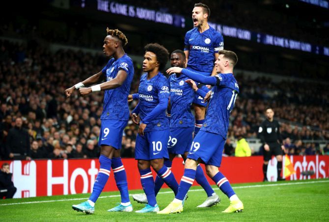 Chelsea's Willian celebrates with teammates after scoring the opening goal against Tottenham Hotspur at Tottenham Hotspur Stadium in London on Sunday