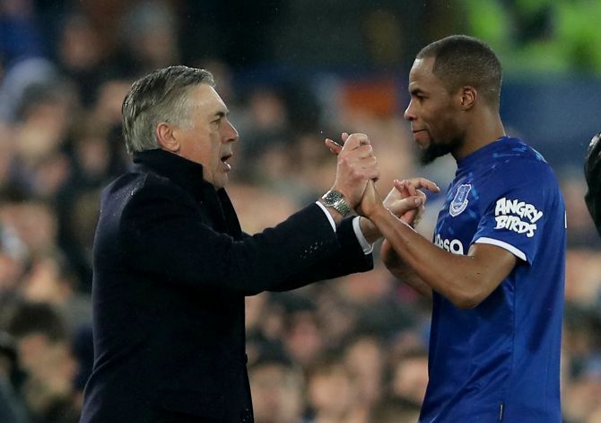 Everton manager Carlo Ancelotti celebrates with Djibril Sidibe after beating Burnley at Goodison Park in  Liverpool 