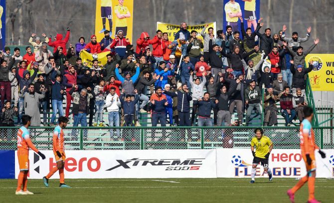 Supporters of Real Kashmir FC celebrate after their team's winning goal against Chennai City FC during their I-League match, in Srinagar on Thursday
