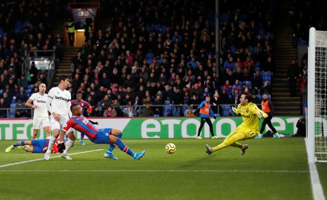 Crystal Palace's Jordan Ayew scores past West Ham United's Roberto Action during their match at Selhurst Park in London