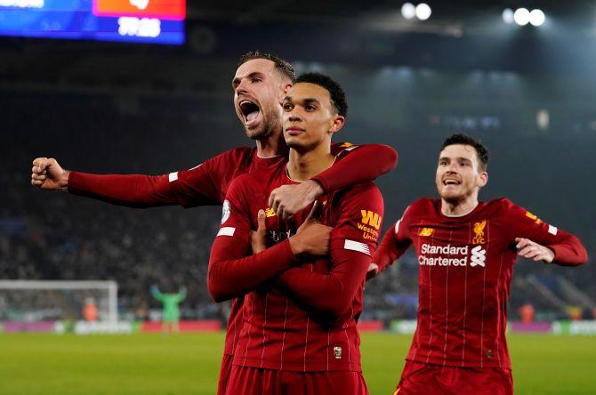 Liverpool's Trent Alexander-Arnold celebrates with Jordan Henderson and Andrew Robertson on netting their fourth goal against Leicester City on Thursday