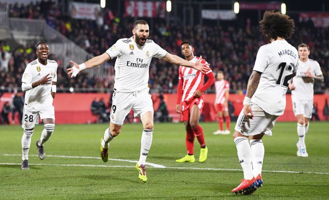 Real Madrid's Karim Benzema celebrates with Marcelo after scoring against Girona during the Copa del quarter-final at Montilivi Stadium in Girona, Spain, on Thursday