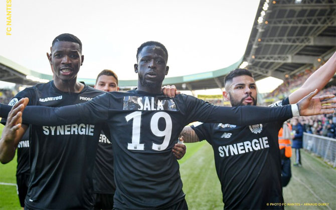 Nantes FC's Majeed Waris celebrates with teammates after scoring against Nimes on Saturday. The team wore an all black kit with the name of Sala on the back