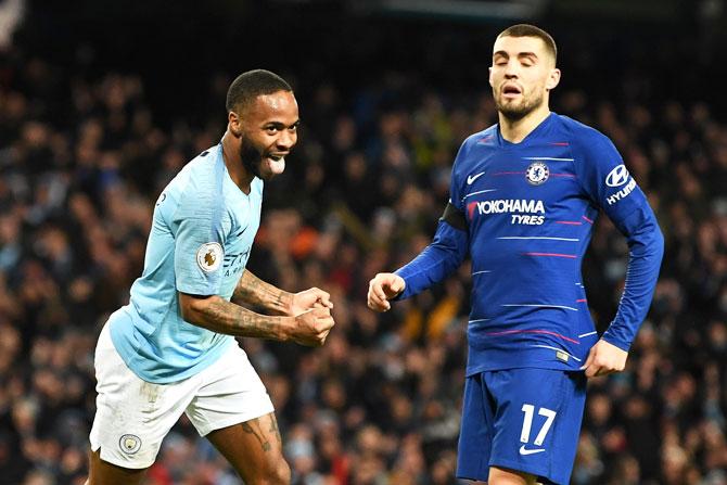 Manchester City's Raheem Sterling celebrates after scoring his team's sixth goal as Chelsea's Mateo Kovacic looks dejected during their EPL game on Sunday