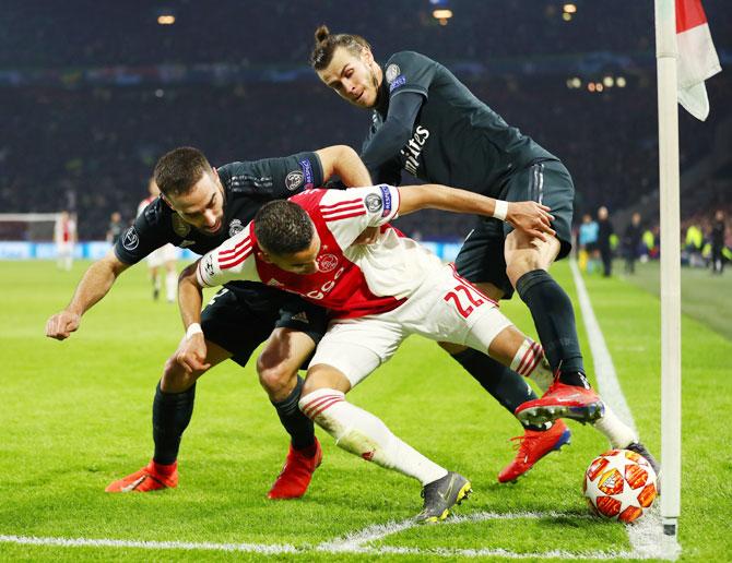 Ajax's Hakim Ziyech is challenged by Real Madrid's Daniel Carvajal and Gareth Bale