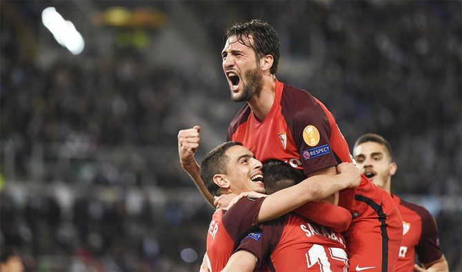 Sevilla players celebrate after scoring against Lazio