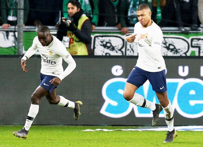 Paris St Germain's Kylian Mbappe (right) celebrates scoring their first goal against AS Saint-Etienne at Stade Geoffroy-Guichard in Saint-Etienne in France on Sunday