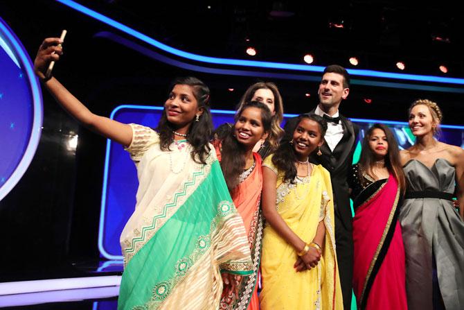 Laureus World Sportsman of The Year 2019 winner Novak Djokovic and his wife Elena take a selfie with Neeta Kumari, Hema Kumari, Konika Kumari, Radha Kumari of the Yuwa-India Football team, at the Laureus World Sports Awards on Monday