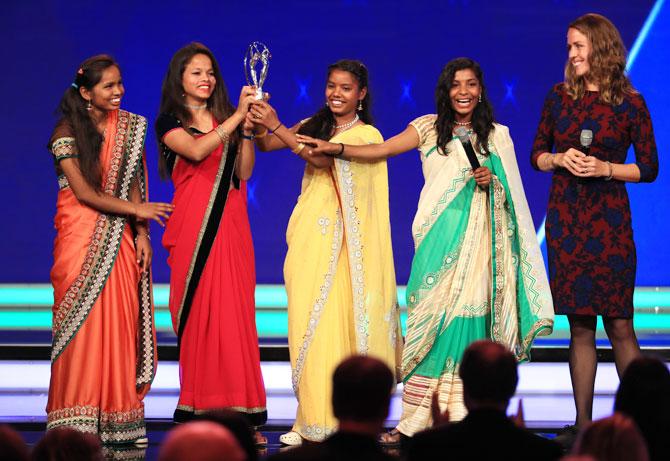 Yuwa-India football's Neeta Kumari, Hema Kumari, Konika Kumari, Radha Kumari, and founders Franz Gastler and Rose Gastler accept their Laureus Good For Sport Award as Laureus Academy Member Missy Franklin and hosts James Marsden, Amanda Davies look on