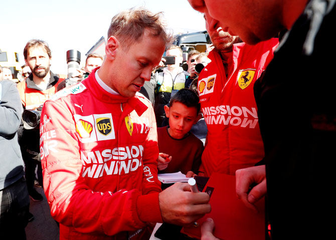 Ferrari's Sebastian Vettel signs autographs during testing at the Circuit de Barcelona-Catalunya, Barcelona on Monday