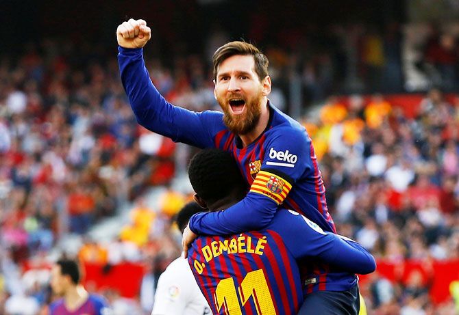 Barcelona's Lionel Messi celebrates scoring their second goal against Sevilla at Ramon Sanchez Pizjuan in Seville, Spain, on Saturday