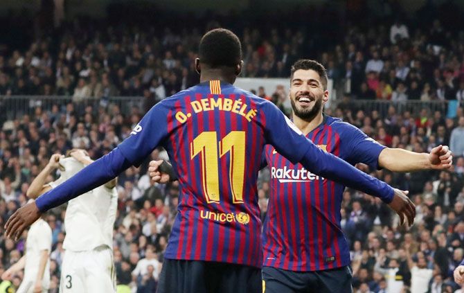 Barcelona's Luis Suarez celebrates with Ousmane Dembele after scoring their second goal against Real Madrid in their semi-final second leg match at Santiago Bernabeu in Madrid on Wednesday