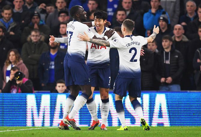 Tottenham Hotspur's Heung-Min Son (7) celebrates after scoring his team's third goal with teammates Kieran Trippier (right) and Moussa Sissoko (left) during their match between Cardiff City at Cardiff City Stadium in Cardiff, United Kingdom, on Tuesday