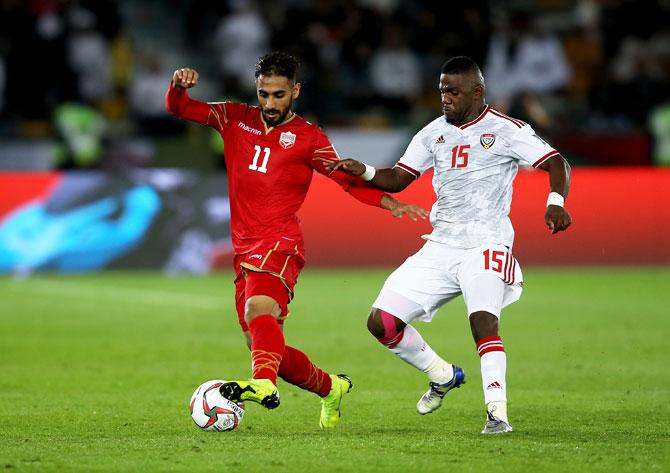 Bahrain's Ali Madan competes for the ball with UAE's Ismail Alhamadi during the AFC Asian Cup Group A match at Zayed Sports City Stadium in Abu Dhabi, United Arab Emirates, on Saturday