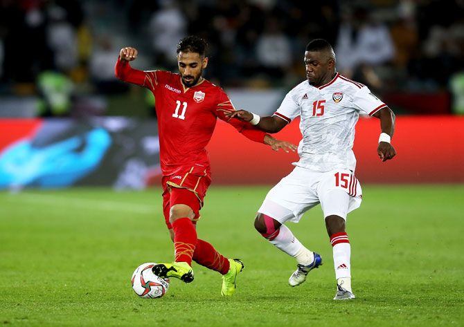 Bahrain's Ali Madan competes for the ball with UAE's Ismail Alhamadi during the AFC Asian Cup Group A match at Zayed Sports City Stadium in Abu Dhabi, United Arab Emirates, on Saturday