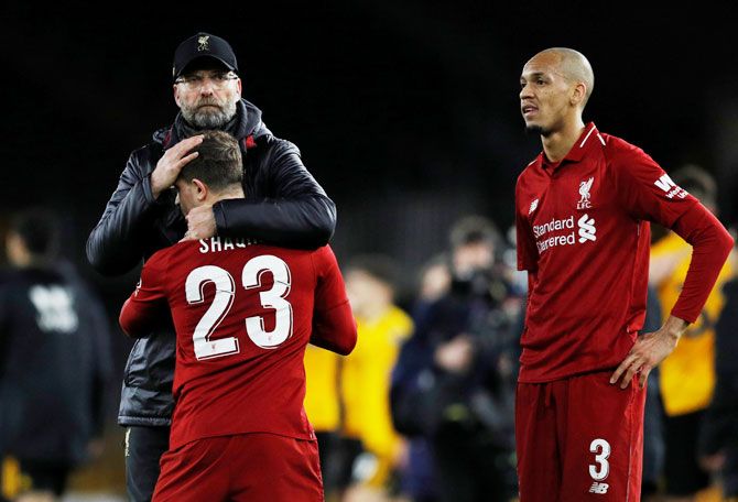Liverpool manager Juergen Klopp consoles Xherdan Shaqiri as Fabinho looks on after being knocked out of the FA Cup by Wolverhampton Wanderers at Molineux Stadium, Wolverhampton, on Monday