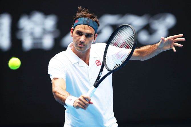 Switzerland's Roger Federer plays a backhand in his second round match against Great Britain's Daniel Evans