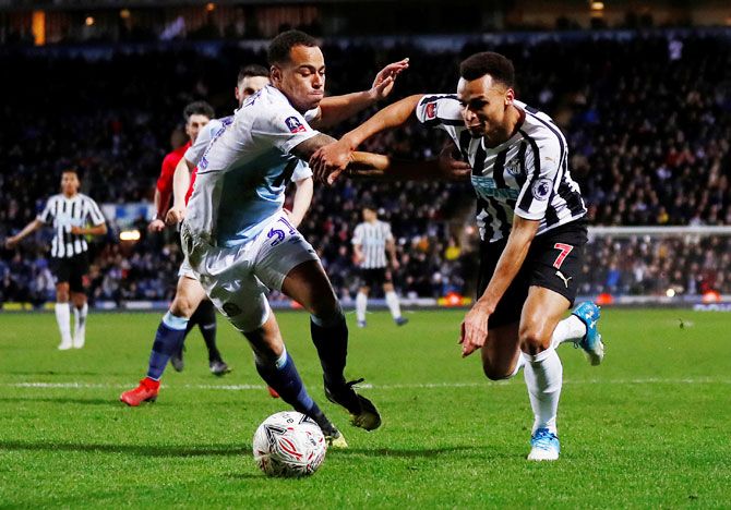 Newcastle United's Jacob Murphy and Blackburn Rovers' Elliott Bennett vie for possession during their FA Cup match at Ewood Park, Blackburn, on Tuesday