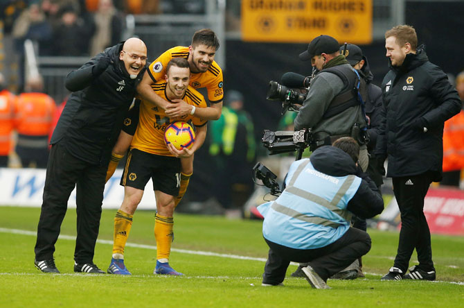 Wolverhampton Wanderers' Diogo Jota and Ruben Neves celebrate after the match against  Leicester City at Molineux Stadium, Wolverhampton