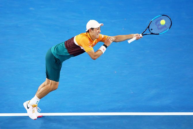 Japan's Kei Nishikori plays a backhand in his fourth round match against Spain's Pablo Carreno Busta