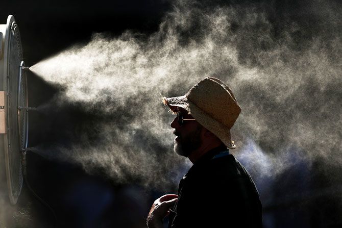 Fans cool off in the hot conditions during day 11 of the 2019 Australian Open at Melbourne Park on January 24, 2019 in Melbourne, Australia