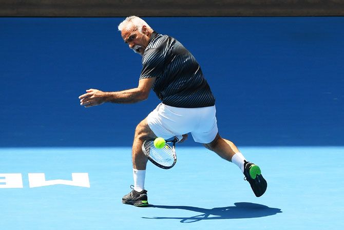 France’s Mansour Bahrami plays a ‘’tweener’ during the men's legends doubles final against Mark Philippoussis Jonas Bjorkman and Thomas Johansson of Sweden on Thursday, January 25