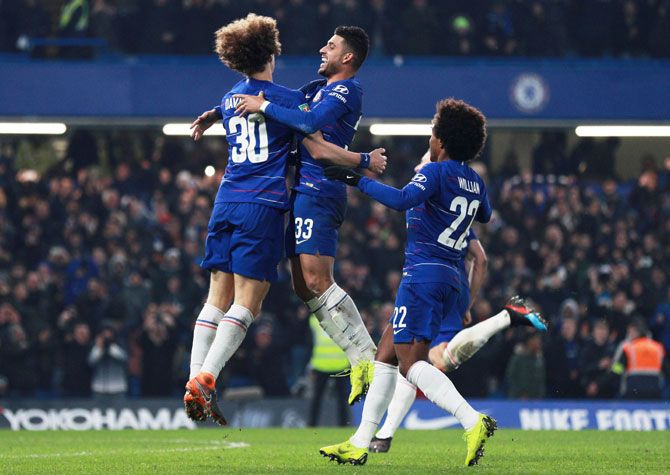 Chelsea's David Luiz, Willian and Emerson Palmieri celebrate winning the match after the penalty shootout against Tottenham in the League Cup Semi-Final Second Leg at Stamford Bridge on Thursday