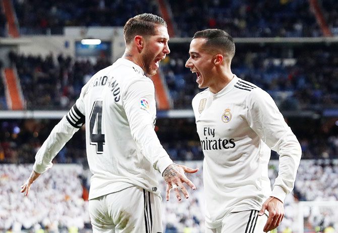 Real Madrid's Sergio Ramos celebrates with teammate Lucas Vazquez after scoring their third goal against Girona on Thursday 