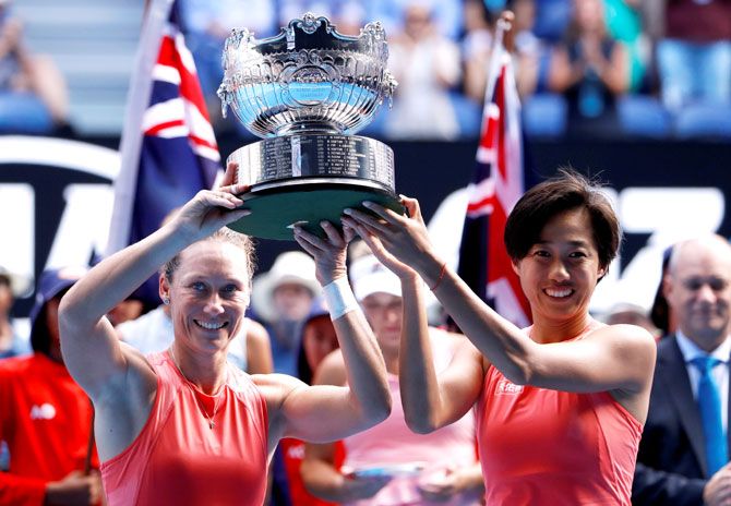 Australia's Samantha Stosur and China's Shuai Zhang celebrate with the trophy after winning the women's doubles final against Hungary's Timea Babos and France's Kristina Mladenovic on Friday