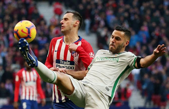 Atletico Madrid's Nikola Kalinic in action with Getafe's Jorge Molina during their La Liga match on Saturday