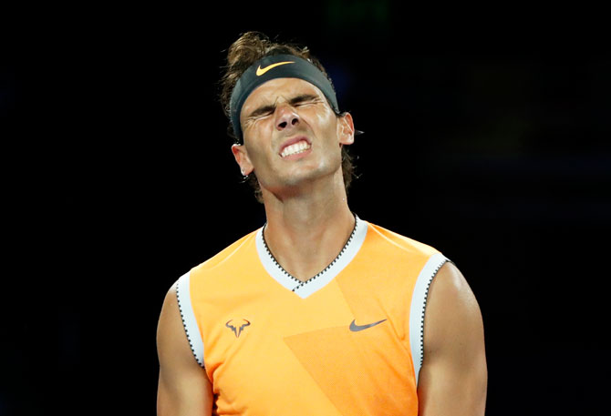 Spain's Rafael Nadal reacts after spraying a forehand wide