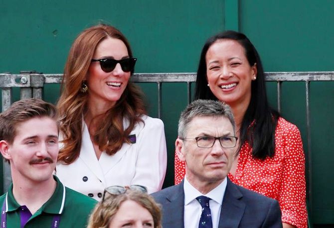 Britain's Catherine, Duchess of Cambridge, sits alongside Anne Keothavong during the first round match between Britain's Harriet Dart and Christina McHale of the United States.
