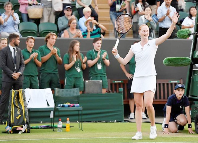 Belgium's Alison Van Uytvanck celebrates winning her second round match against Spain's Garbine Muguruza.