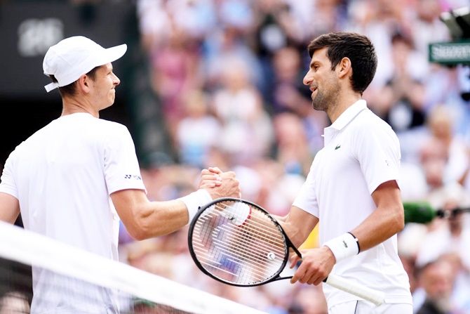 Novak Djokovic congratulates Hubert Hurkacz on his 'great effort' after their third round match, which he won 7-5, 6-7(5), 6-1, 6-4. Photograph: Laurence Griffiths/Getty Images