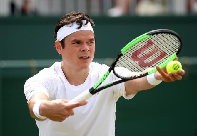 Milos Raonic, 6 feet 5 inches, serves during his third round match against Reilly Opelka, 6 feet, 11 inches. The shorter man won 7-6 (1), 6-2, 6-1Photograph: Carl Recine/Reuters