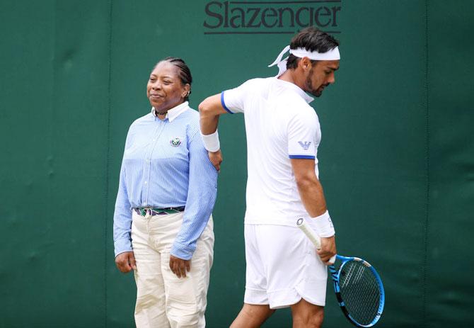 Italy's Fabio Fognini apologises to a line judge during his Wimbledon third round match against USA's Tennys Sandgren on Saturday.