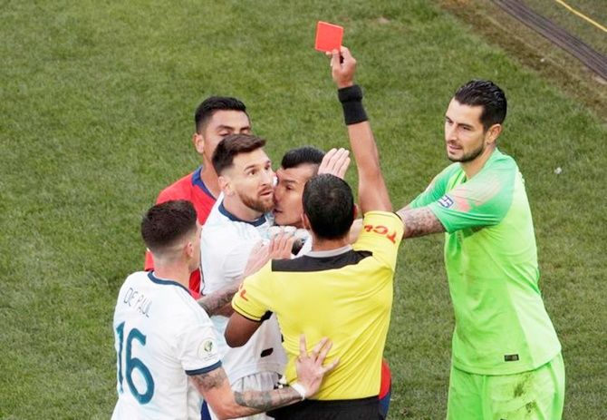 Chile's Gary Medel and Argentina's Lionel Messi are shown the red card by referee Mario Diaz de Vivar during the Copa America third place play-off