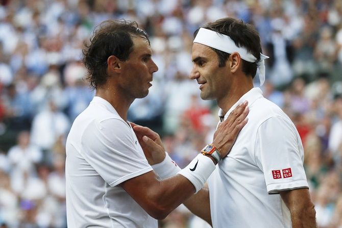Roger Federer and Rafael Nadal embrace at the net after their men's singles semi-final
