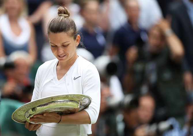 Simona Halep celebrates with the Wimbledon trophy on Sunday