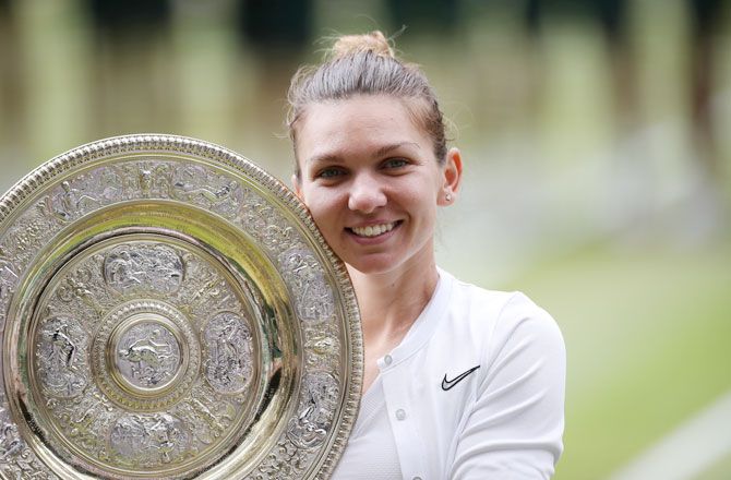 Romania's Simona Halep celebrates with the trophy after winning the Wimbledon final against USA's Serena Williams on Saturday