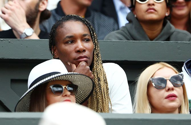 Venus Williams wears a worried look as she watches sister Serena struggle