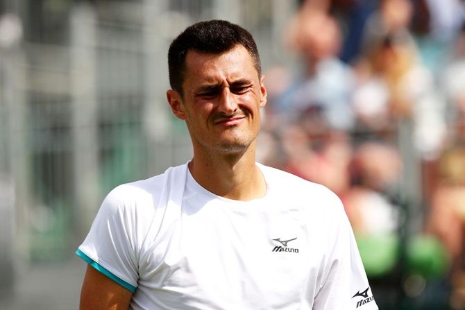 Australia's Bernard Tomic reacts during his men's singles first round match against France's Jo-Wilfred Tsonga on Day 2 of The Championships - Wimbledon 2019.